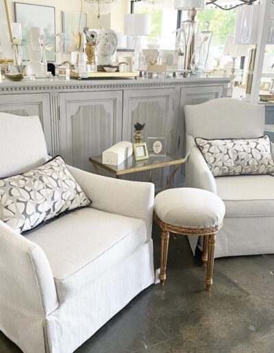 A pair of white chairs in a store.