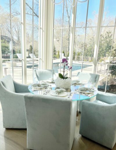 A dining room with a glass table and chairs.